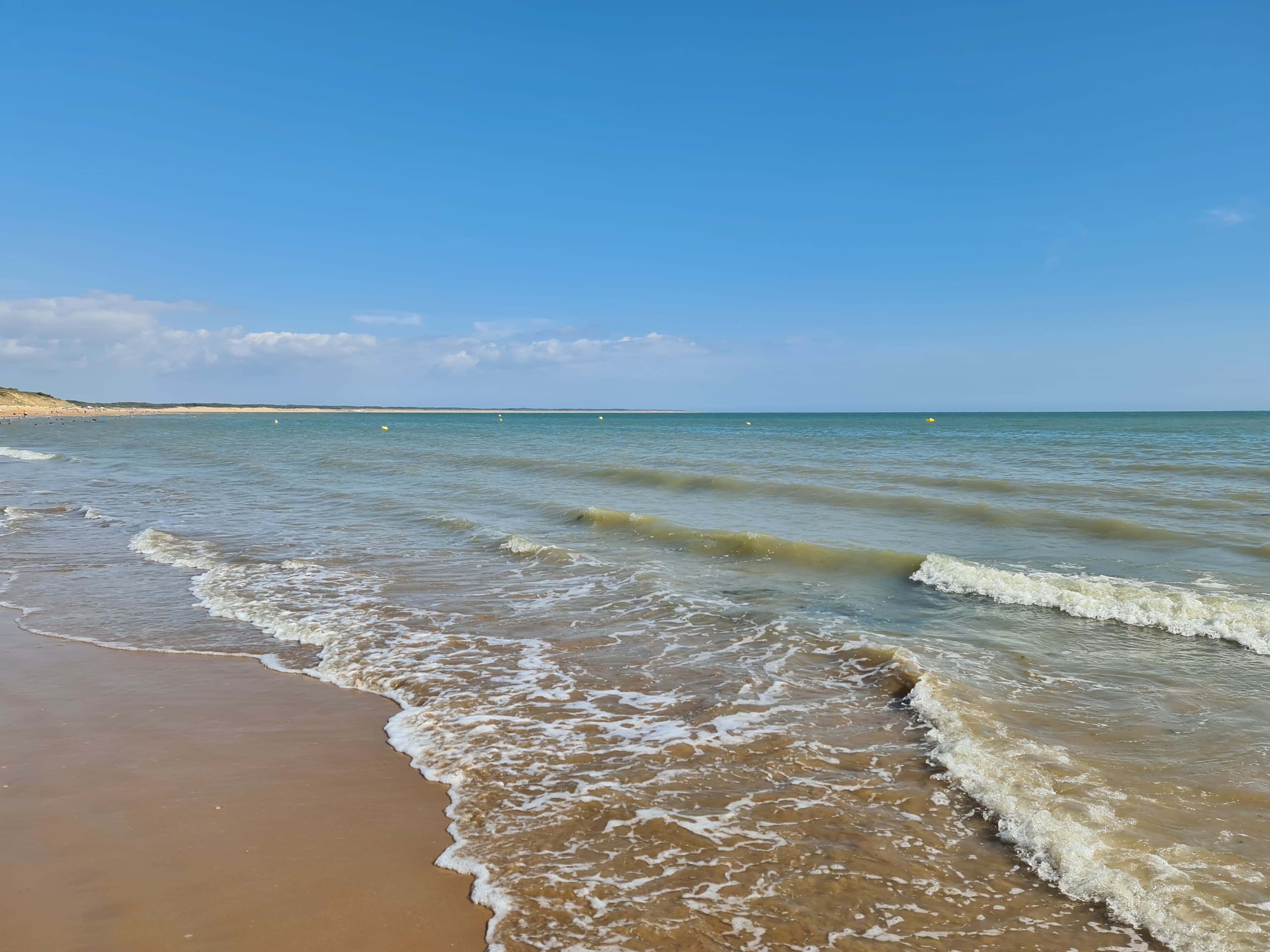 Helder strand met turquoise zee en blauwe lucht
